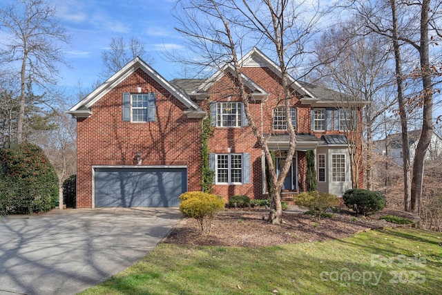 view of front of home featuring a garage, driveway, and brick siding