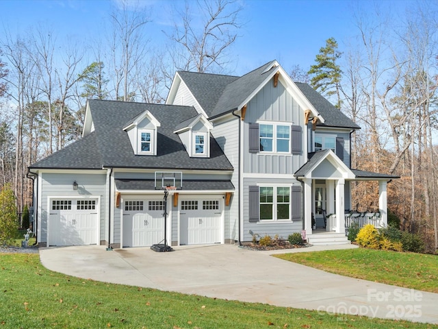 view of front of property with a shingled roof, concrete driveway, an attached garage, a front lawn, and board and batten siding