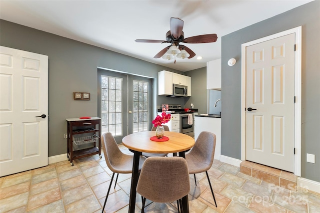 dining space with ceiling fan, french doors, and baseboards