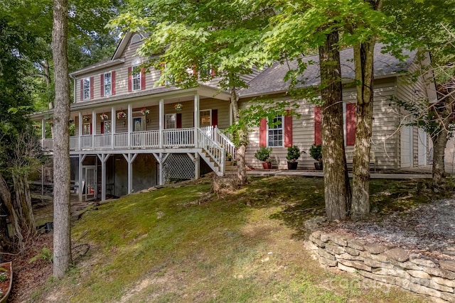 view of front of home with covered porch and a front yard