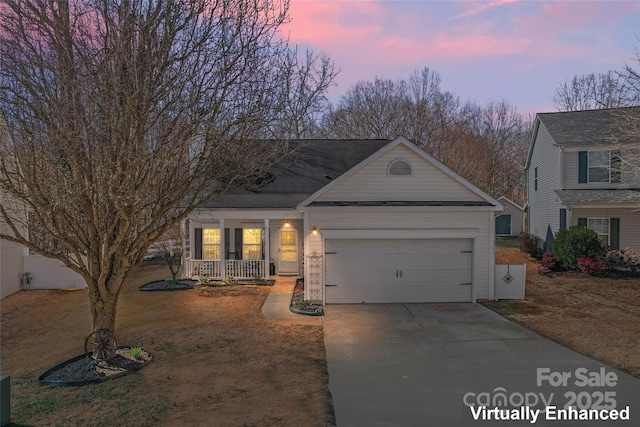 view of front of home with driveway, a porch, and an attached garage