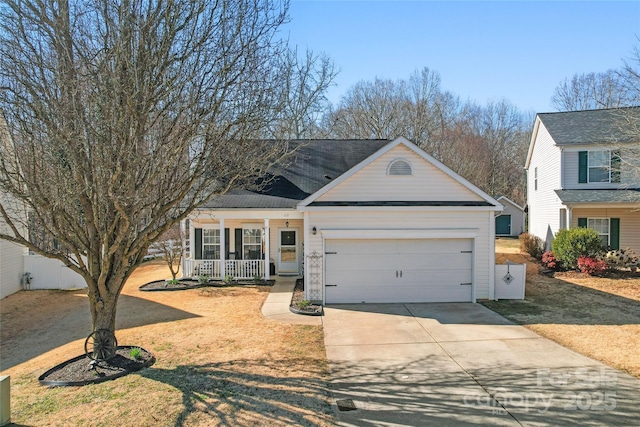 traditional-style home featuring a front lawn, fence, a porch, driveway, and an attached garage