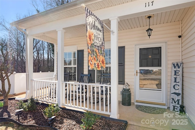 view of exterior entry with a porch