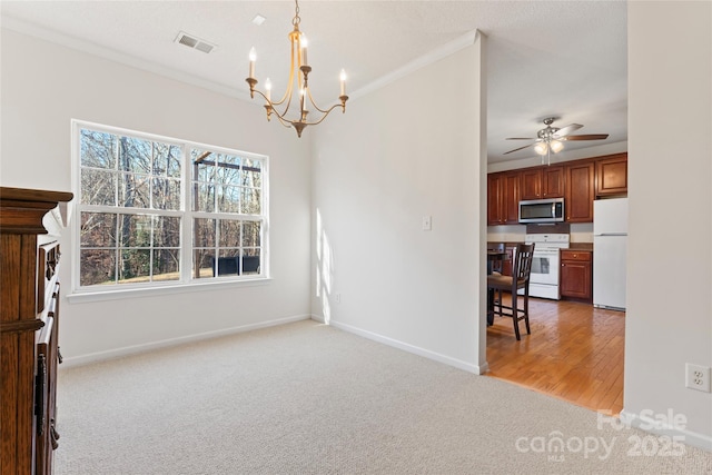 interior space featuring ornamental molding, light colored carpet, visible vents, and baseboards