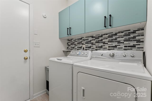 laundry area with washer and dryer and cabinet space