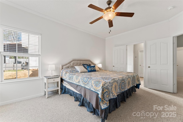 bedroom featuring baseboards, crown molding, and carpet