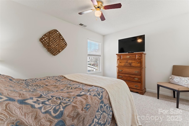 carpeted bedroom featuring baseboards, visible vents, and ceiling fan