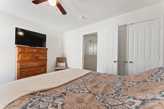 bedroom with a ceiling fan, a closet, and a textured ceiling