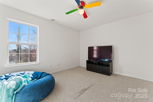 living area with visible vents, baseboards, and carpet