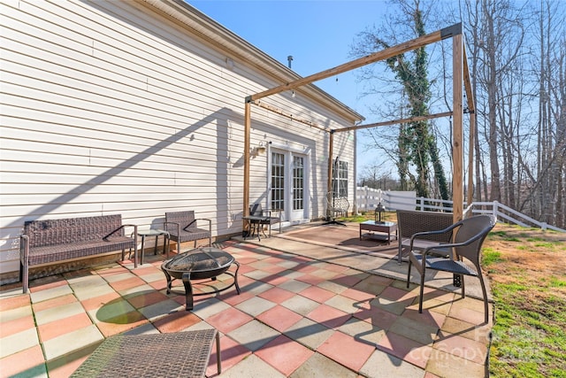 view of patio / terrace with fence and an outdoor fire pit