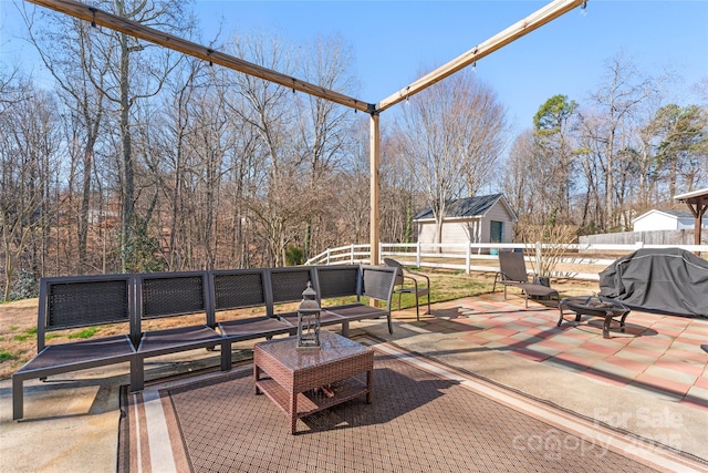 view of patio featuring a grill, an outdoor structure, and fence