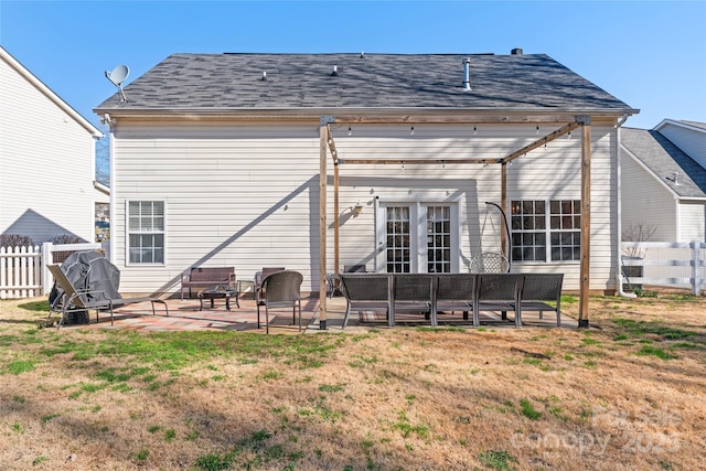 back of house with an outdoor living space, a patio, a lawn, and fence