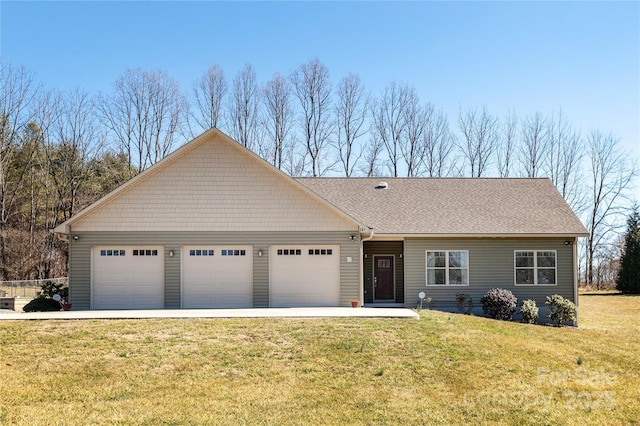 view of front of home with a garage, roof with shingles, and a front yard