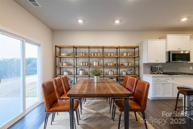 dining room with dark wood-style floors, recessed lighting, and visible vents