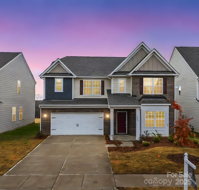 view of front of home with a garage, concrete driveway, board and batten siding, and brick siding