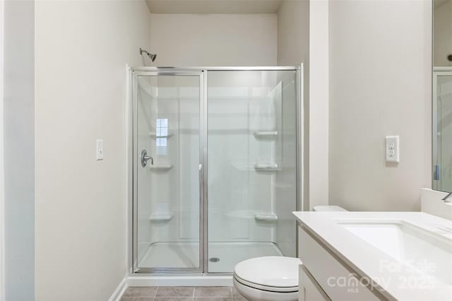 full bathroom featuring toilet, tile patterned floors, a shower stall, and vanity