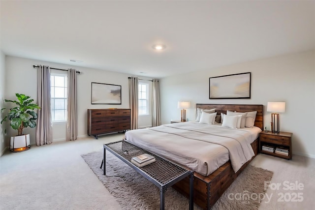 bedroom featuring baseboards and light colored carpet