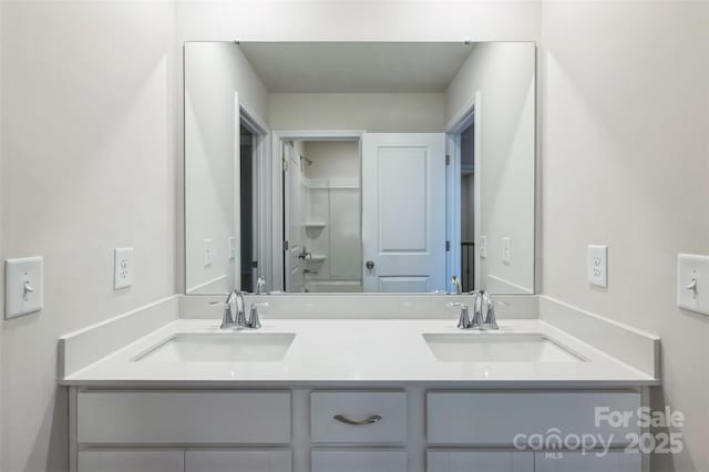 full bathroom featuring a sink and double vanity