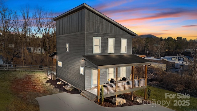 view of front of home featuring fence and a deck