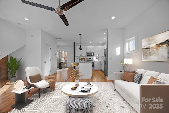 living room featuring recessed lighting and light wood-style floors