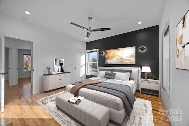 bedroom with multiple windows, light wood-style flooring, and recessed lighting