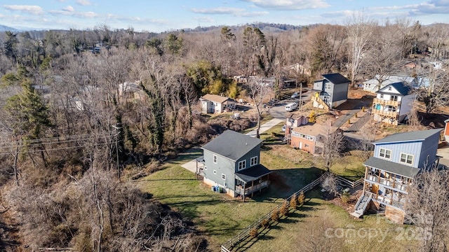 bird's eye view featuring a residential view and a wooded view