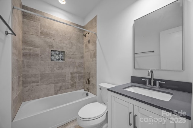 bathroom featuring toilet,  shower combination, and vanity