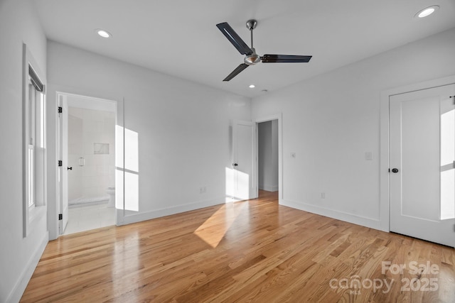 unfurnished bedroom featuring recessed lighting, connected bathroom, light wood-style flooring, and baseboards