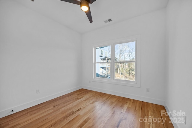 unfurnished room with a ceiling fan, light wood-style flooring, visible vents, and baseboards