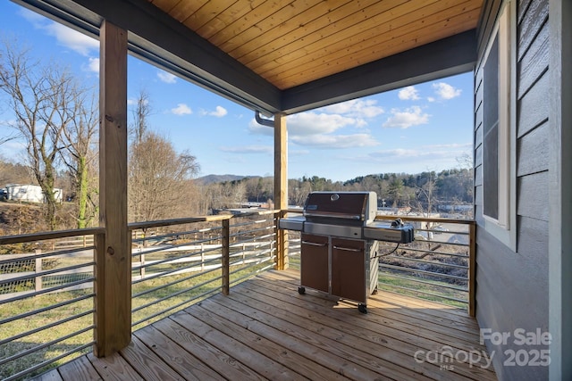 wooden deck featuring a grill