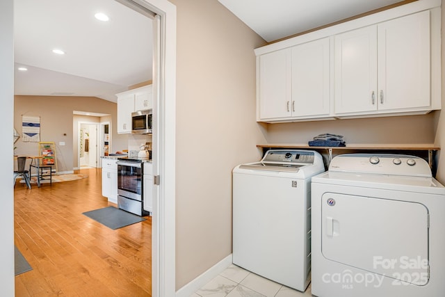 washroom featuring cabinet space, baseboards, independent washer and dryer, light wood-type flooring, and recessed lighting