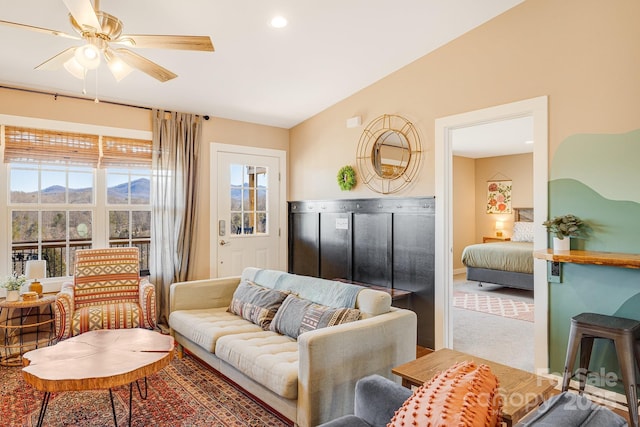 carpeted living room with recessed lighting, vaulted ceiling, ceiling fan, a mountain view, and baseboards