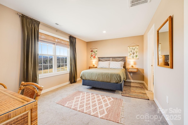 carpeted bedroom featuring baseboards and visible vents