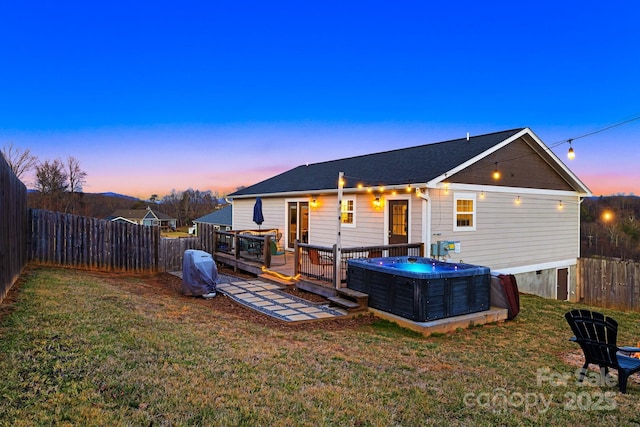 back of house featuring a deck, a yard, central AC unit, and a fenced backyard