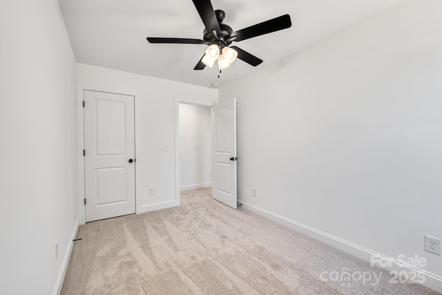 unfurnished bedroom featuring ceiling fan, baseboards, and light colored carpet