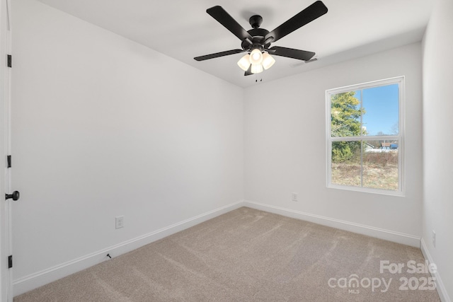 unfurnished room with light carpet, baseboards, and a ceiling fan