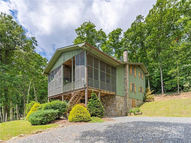167 Bold Springs Rd, Sylva, NC 28779 - view of front of house with a chimney, stairway, driveway, a front yard, and a sunroom