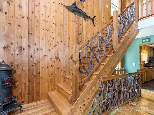 167 Bold Springs Rd, Sylva, NC 28779 - stairway with wood walls, a wood stove, a towering ceiling, and wood finished floors