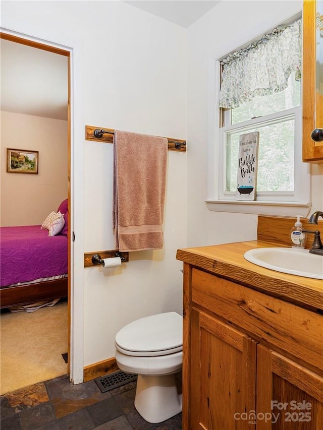 167 Bold Springs Rd, Sylva, NC 28779 - ensuite bathroom featuring visible vents, toilet, stone finish floor, connected bathroom, and vanity