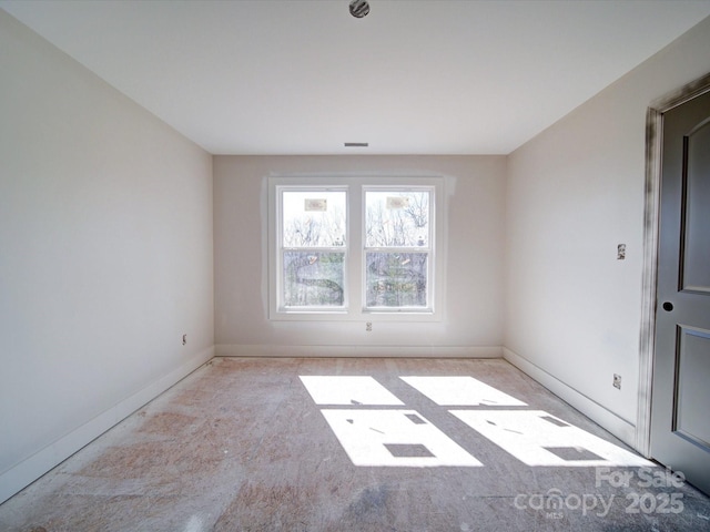 empty room with visible vents and baseboards