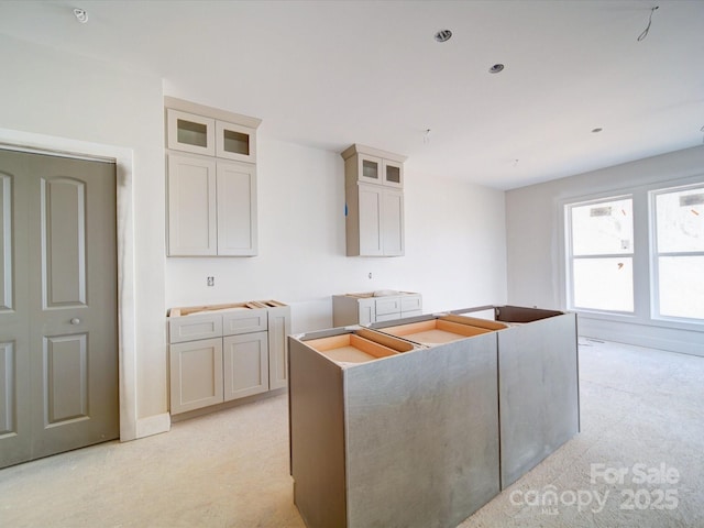 kitchen with a kitchen island and glass insert cabinets