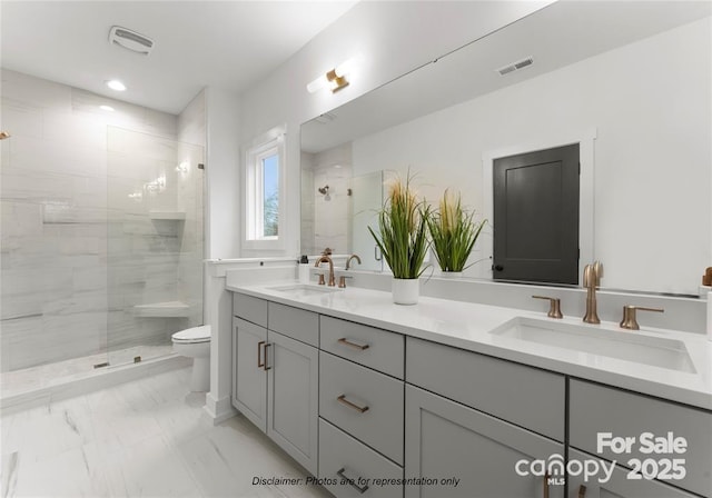 full bathroom featuring double vanity, marble finish floor, a sink, and tiled shower