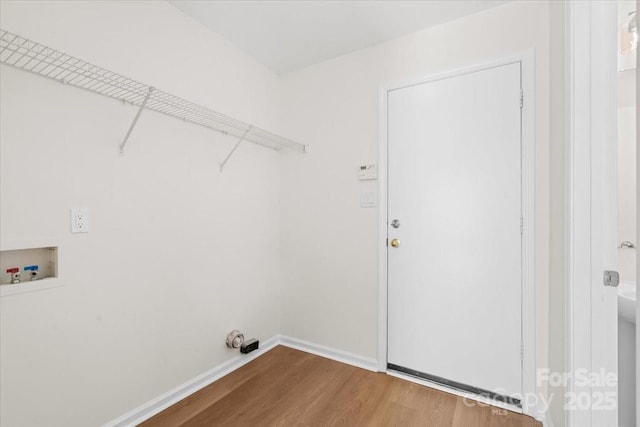 laundry room with washer hookup, laundry area, baseboards, and wood finished floors