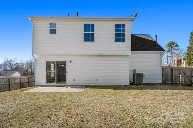 rear view of property featuring a patio, a lawn, and a fenced backyard