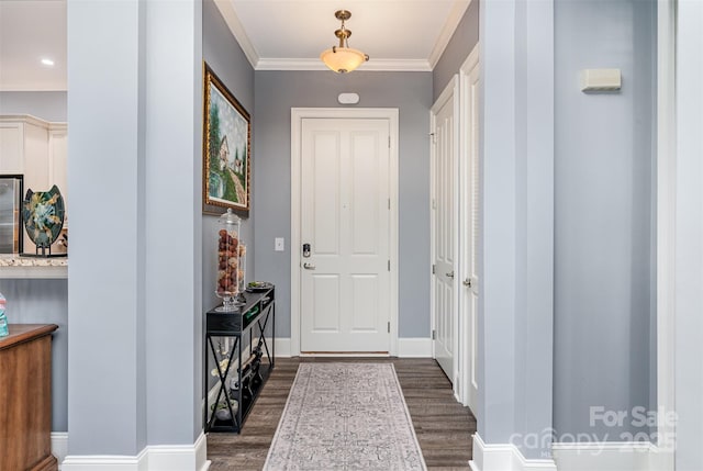 entrance foyer with dark wood-style floors, baseboards, and crown molding