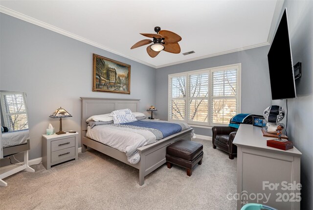 bedroom with light carpet, a ceiling fan, visible vents, baseboards, and ornamental molding