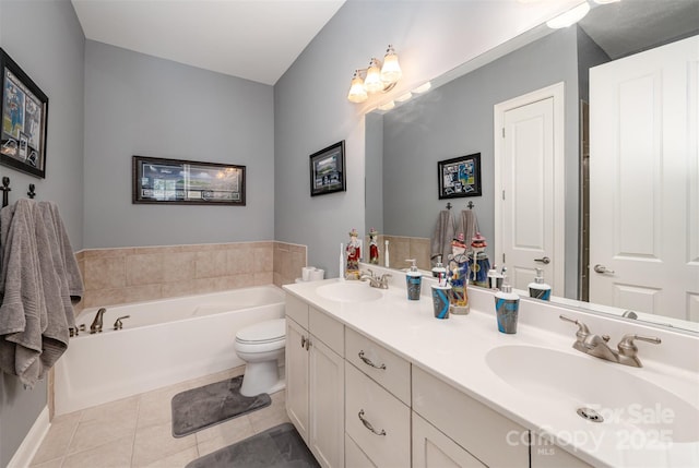 full bathroom featuring a garden tub, double vanity, tile patterned flooring, and a sink