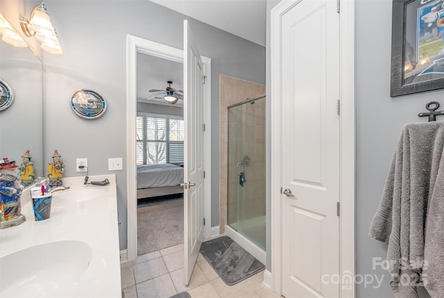 bathroom with tile patterned flooring, a sink, double vanity, a stall shower, and ensuite bath