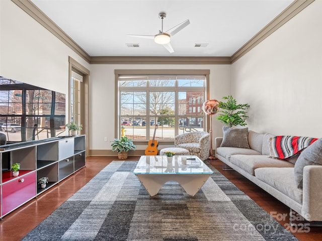 living area featuring visible vents, wood finished floors, and ornamental molding