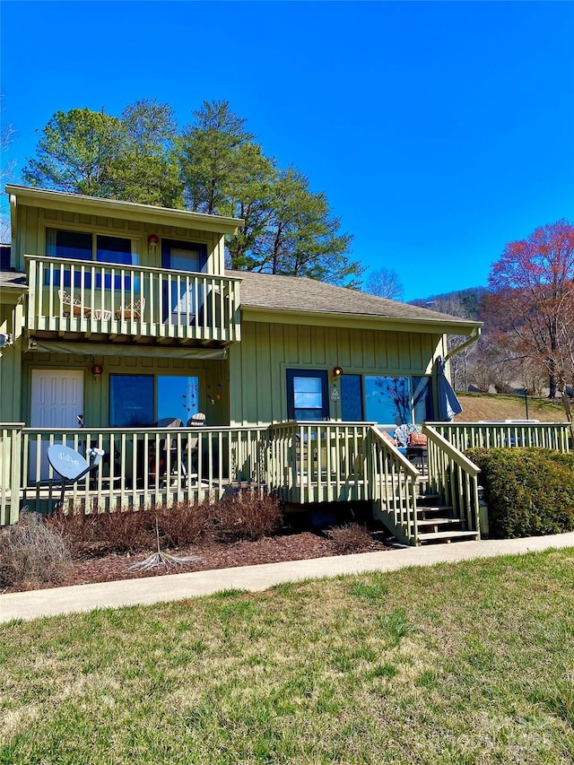 view of front of house featuring board and batten siding, a balcony, and roof with shingles